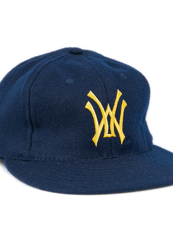 The West Virginia University 1966 Vintage Ballcap by Ebbets Field Flannels is a dark blue cap with a flat brim and yellow interlocking W logo, inspired by the classic style of the 1966 Mountaineers.