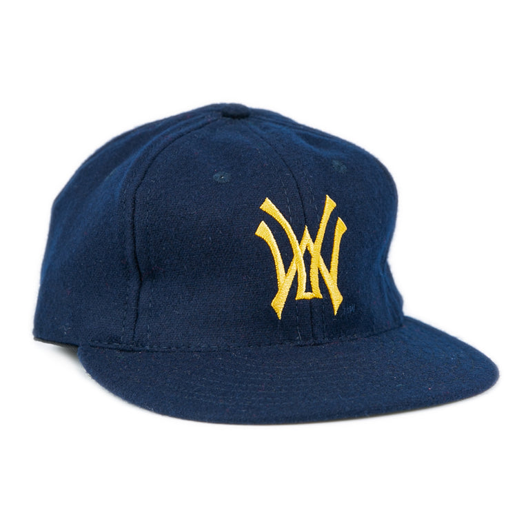 The West Virginia University 1966 Vintage Ballcap by Ebbets Field Flannels is a dark blue cap with a flat brim and yellow interlocking W logo, inspired by the classic style of the 1966 Mountaineers.