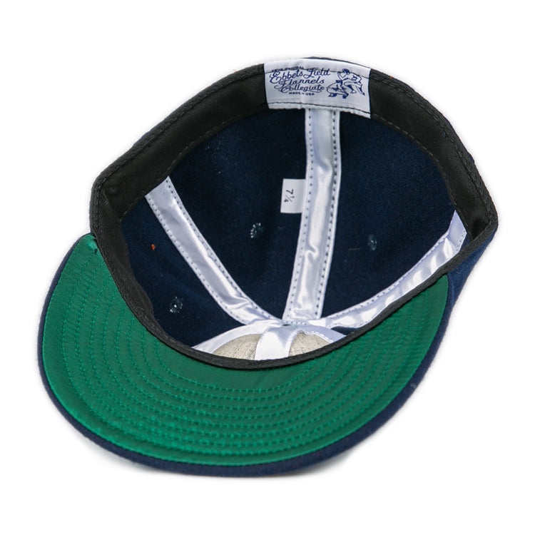 The Ebbets Field Flannels West Virginia University 1966 Vintage Ballcap in navy features a green underbrim, white lining, an inner label, and size 7 1/4—capturing the classic Mountaineers look.