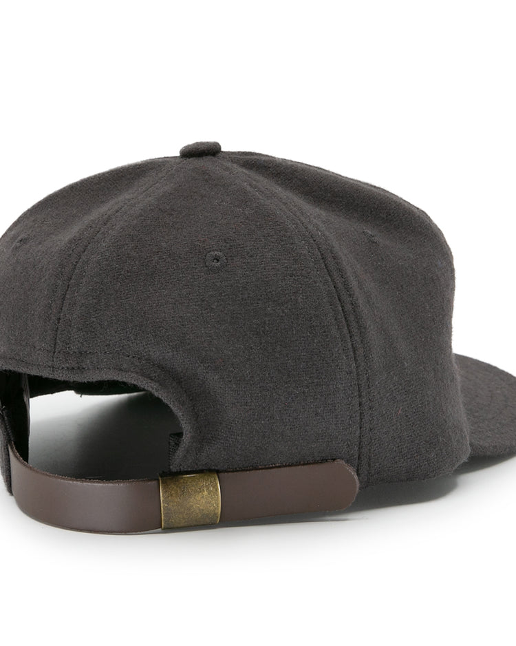 The image shows the back view of the EFF Young Democrats 1972 Vintage Inspired Ballcap in dark gray, featuring a curved brim and a brown leather adjustable strap with a brass buckle.