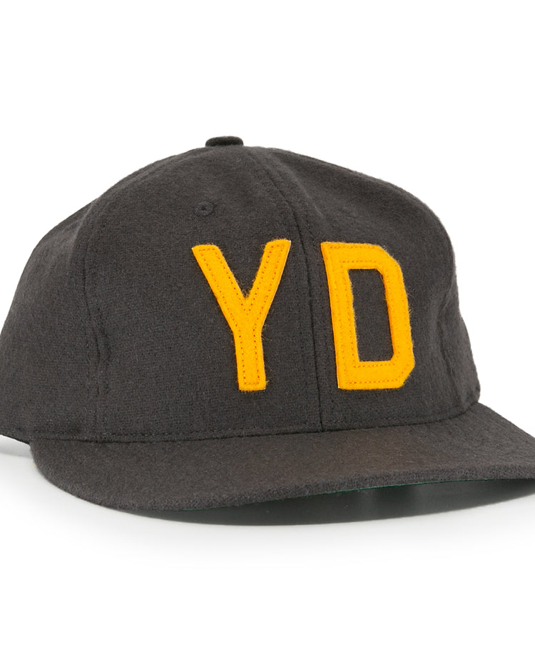 The EFF Young Democrats 1972 Vintage Inspired Ballcap is a dark grey wool six-panel cap with a curved brim and yellow Y and D embroidery, capturing classic Little League baseball style.