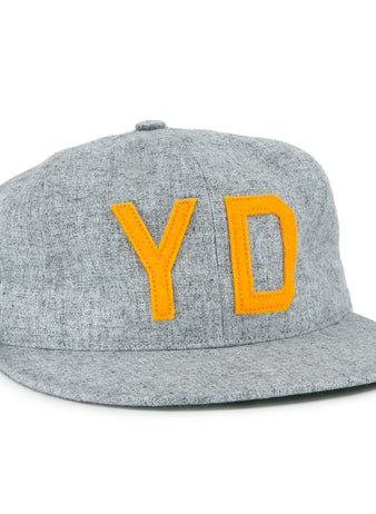 The EFF Hoboken Young Democrats 1972 Vintage Ballcap is a gray wool hat with bold yellow Y and D letters, inspired by the classic Little League style and the original 1972 Hoboken Young Democrats cap.
