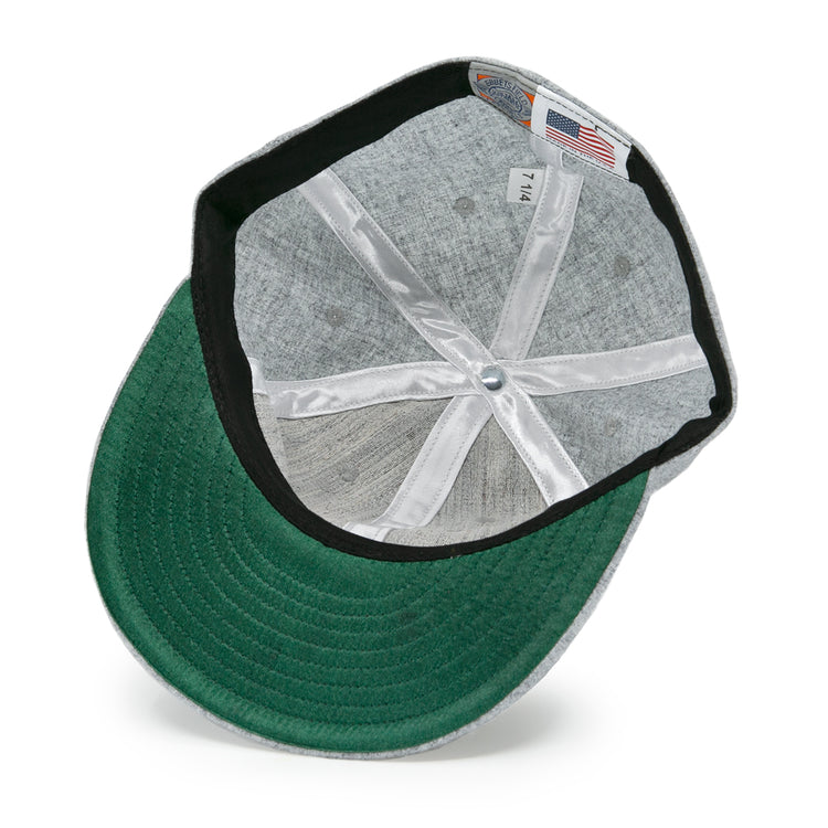 The underside of the EFF Hoboken Young Democrats 1972 Vintage Ballcap shows a green brim, black inner band, white stitching, a 7 1/4 size tag, and an American flag tag.