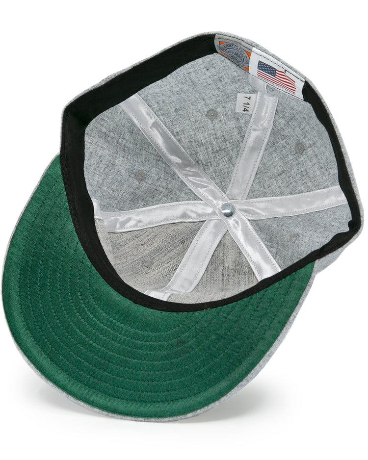 The underside of the EFF Hoboken Young Democrats 1972 Vintage Ballcap shows a green brim, black inner band, white stitching, a 7 1/4 size tag, and an American flag tag.