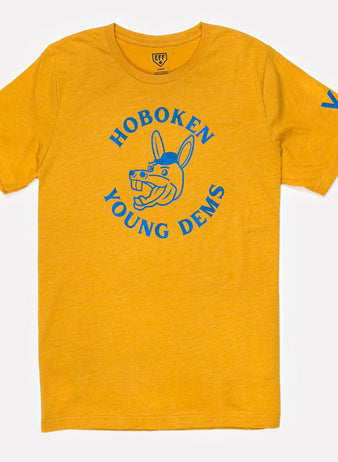 The Hoboken Young Democrats T-Shirt by Ebbets Field Flannels is a yellow unisex tee featuring blue “Hoboken Young Dems” text, a cartoon donkey head on the front, and a sporty blue “Y” on the left sleeve.