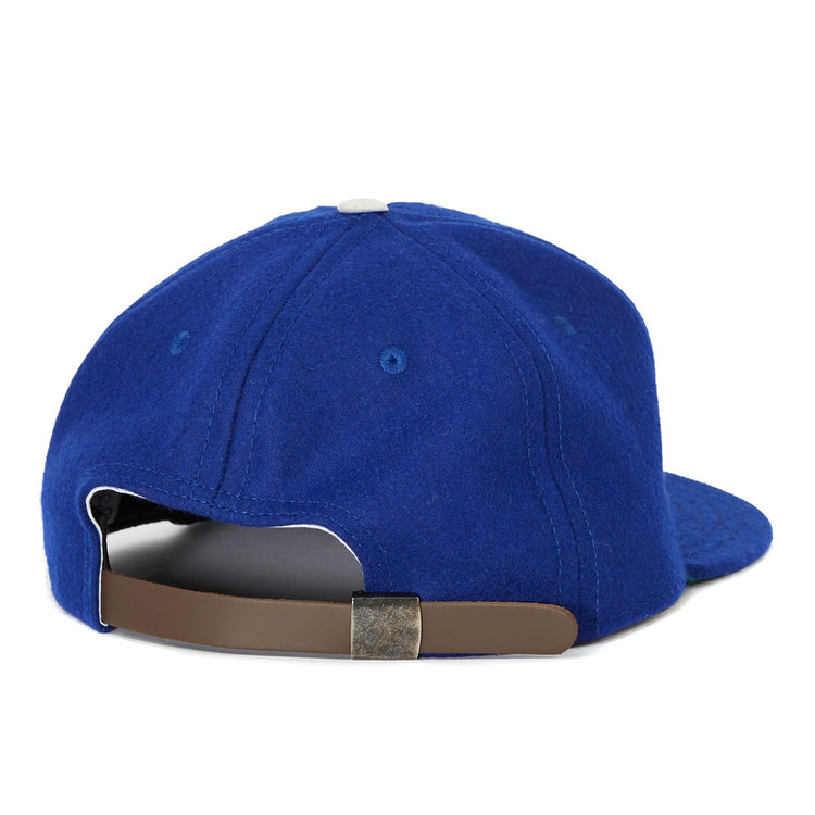 The EFF Oakland Oaks 1950 Vintage Ballcap features blue fabric, a white top button, and a brown adjustable strap with metal clasp—classic style echoing the original Pacific Coast League design.